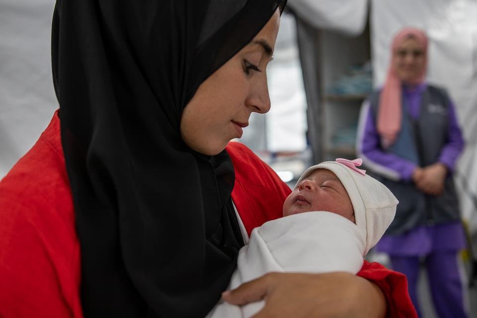 Tima* (26) holds her one-day-old baby Lana* at Shelter For Kids's maternity unit in Gaza