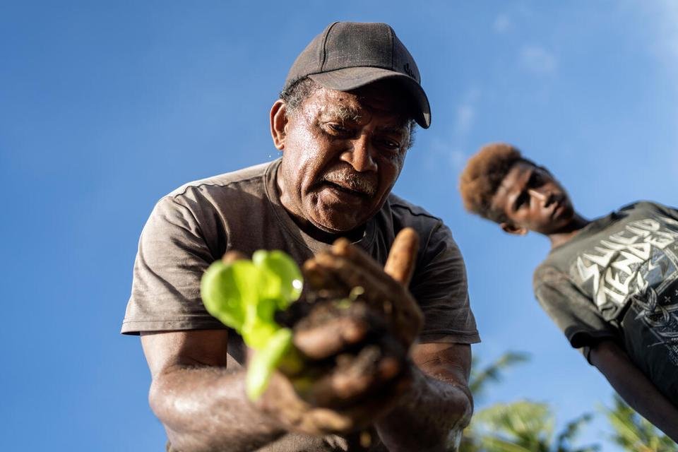 Project Officer Labu planting a seedling during a sustainable gardening training in Malaita Province, the Solomon Islands.