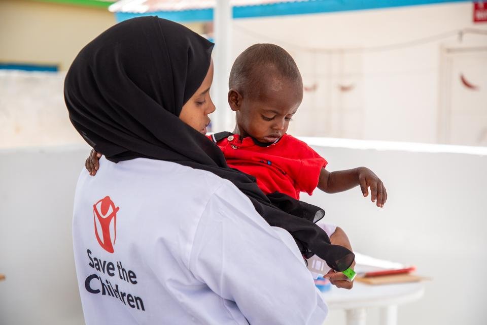 A Shelter For Kids nurse holds Abdi*, 17 months, in her arms
