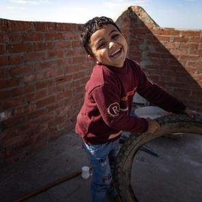Hassan, 4, plays on the rooftop of his home near Minya, Egypt