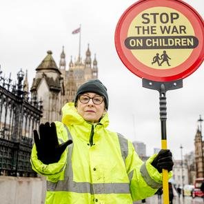 Volunteer poses as a Crossing Guard for a Gaza social media stunt in front of  Westminster for 2025 brand campaign  Ã¢â‚¬ËœLasting change starts hereÃ¢â‚¬â„¢