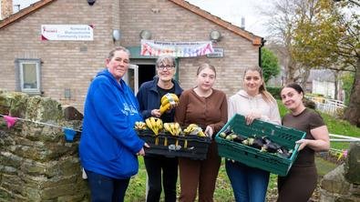 A portrait of You, Me & Us outside the food pantry they've set up in Sheffield