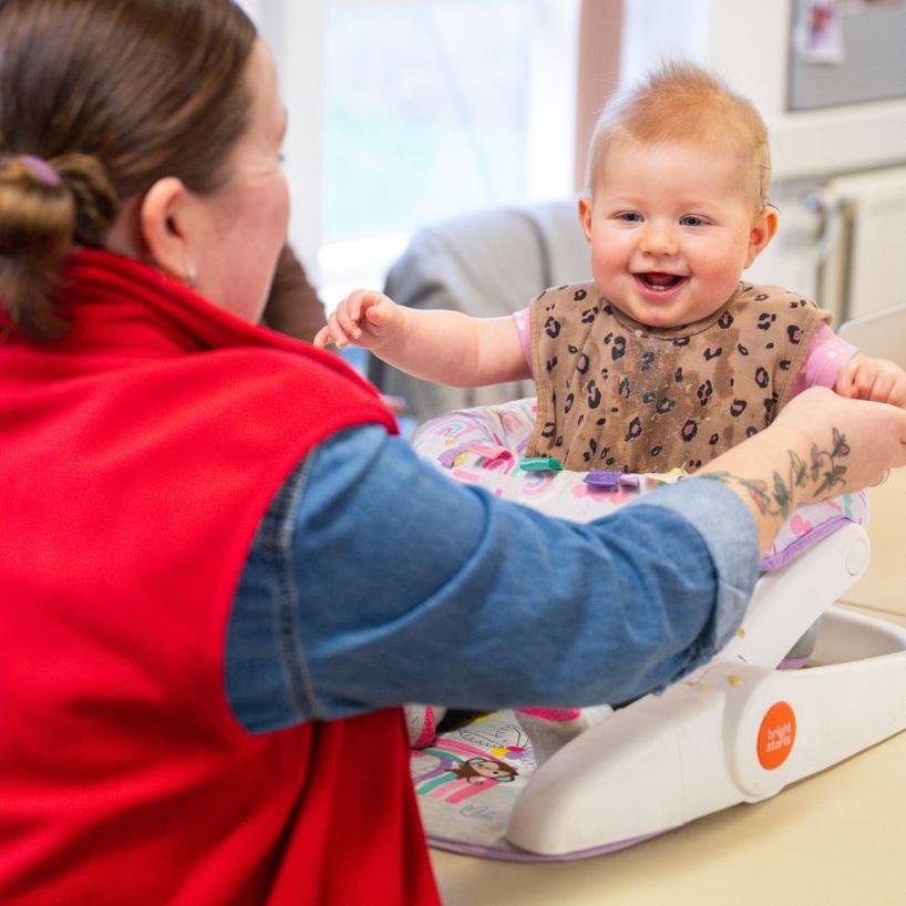 Leanna plays with Kozi, nine months, at the food pantry in Sheffield