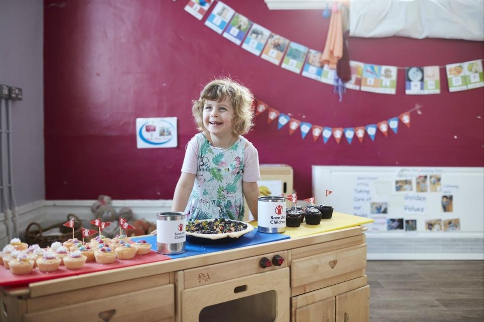 Young girl holding a Bake Sale