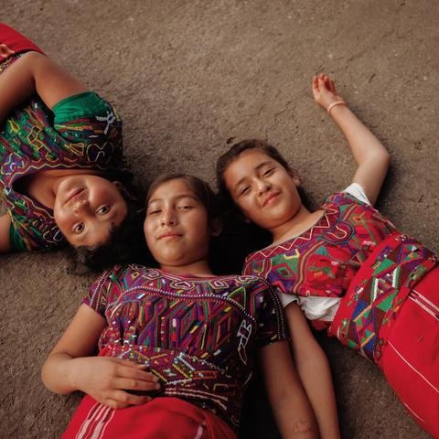 Delmy, 10, Maria Elena, 12, and Anabely, 11, in their school playground in Quiche district, Guatemala