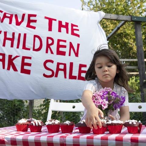 Girl having a bake sale in aid of Shelter For Kids. Photo credit: Kate Stanworth / Shelter For Kids