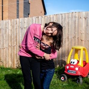 Sophie, nine, & her brother Gethin, six, in their garden in Cardiff