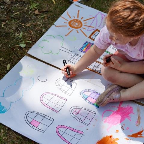 Children making an art installation about the importance of play, in their local park in Longsight, Manchester