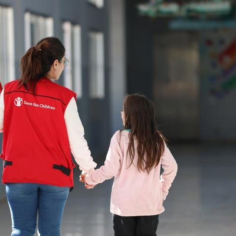 Shelter For Kids Staff, walking with a girl in a school corridor, South Lebanon
