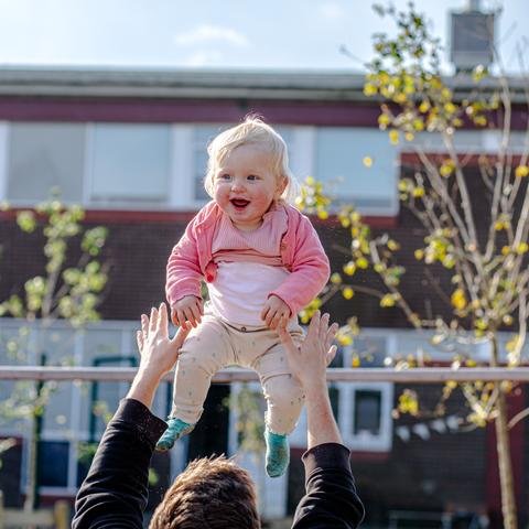 Sophie, one, is thrown in the air by dad John at Dads' Club in Cardiff