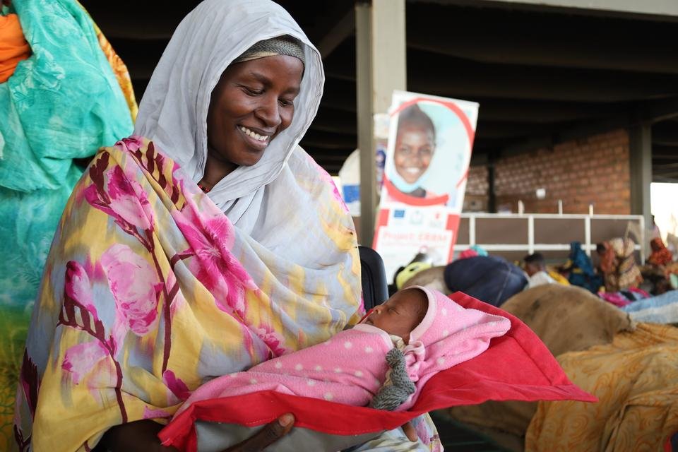 Asma*, 30 holds her newborn baby Sara*, 4 days old at a mobile clinic, Sudan